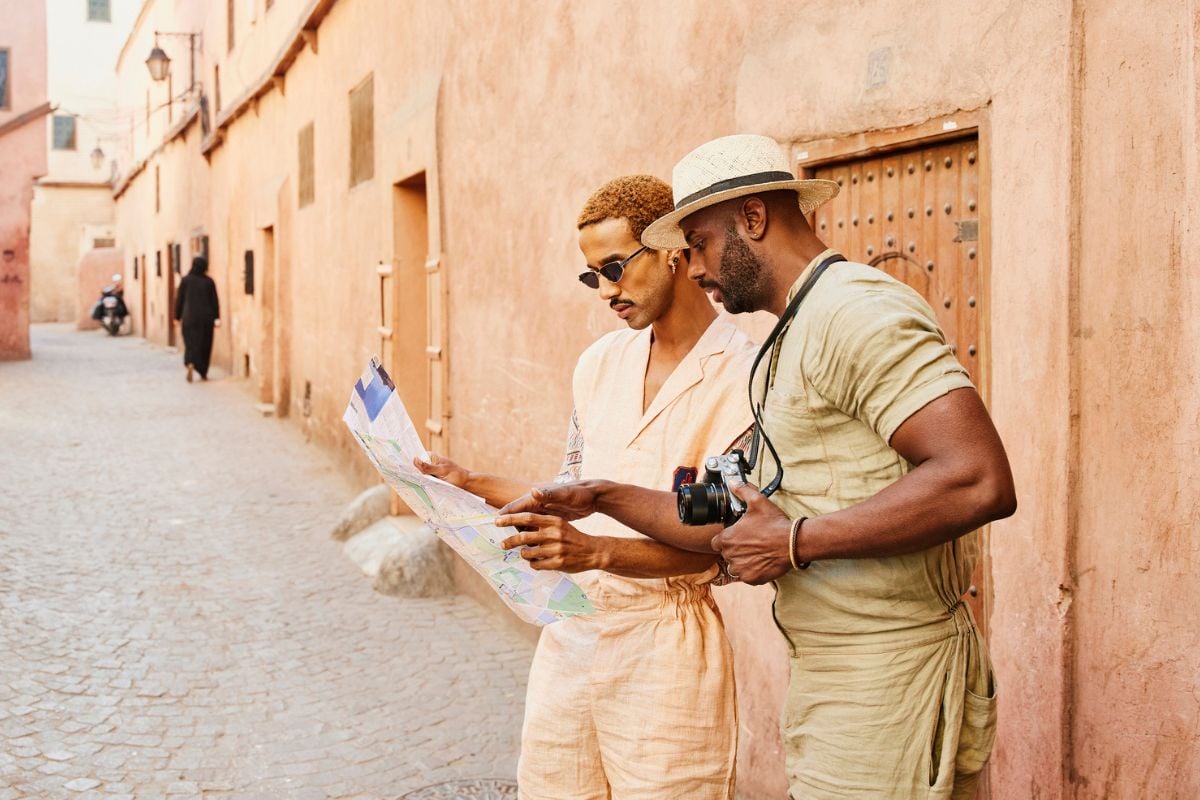 two men looking at map with camera in Morocco