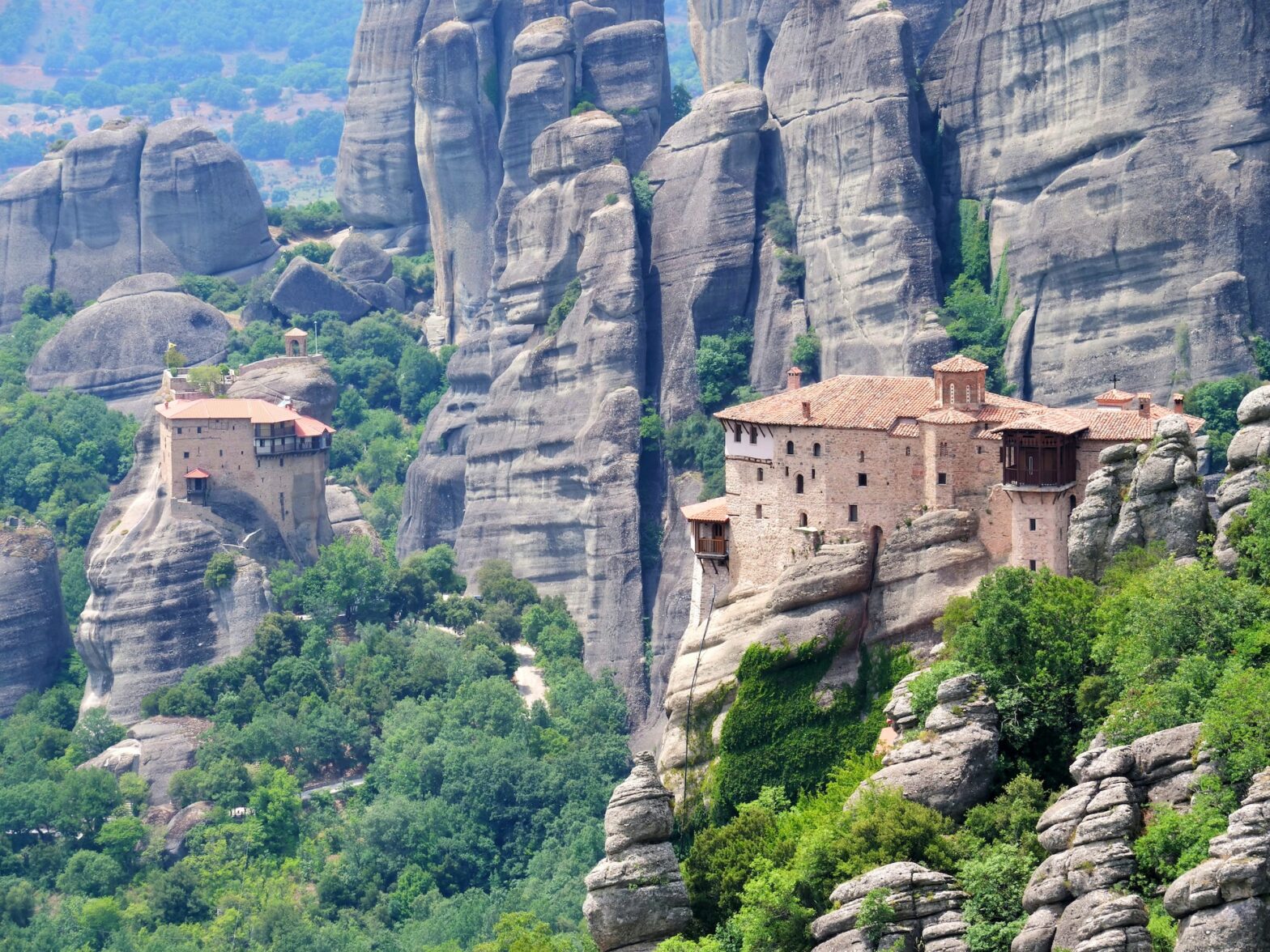 Where was "For Your Eyes Only" filmed? One location was Meteora. Pictured: A wide shot of a beautiful cliffside surrounded by foliage.