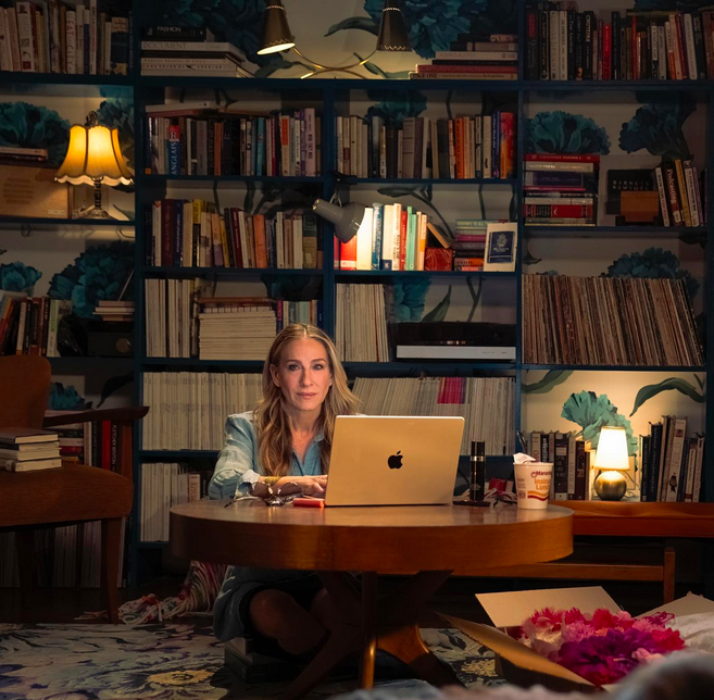 Carrie Bradshaw's apartment, you may ask? Well, we have all the details on where the iconic apartment is located at in Sex and the City. Here in this picture is Sarah Jessica Parker, who portrays Carrie Bradshaw in both "Sex an the City" and in "And Just Like That" pretending to write her column on her trusty Mac in her NYC apartment.