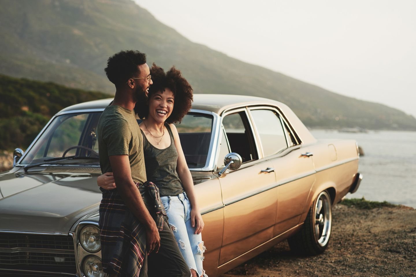 couple standing next to car together