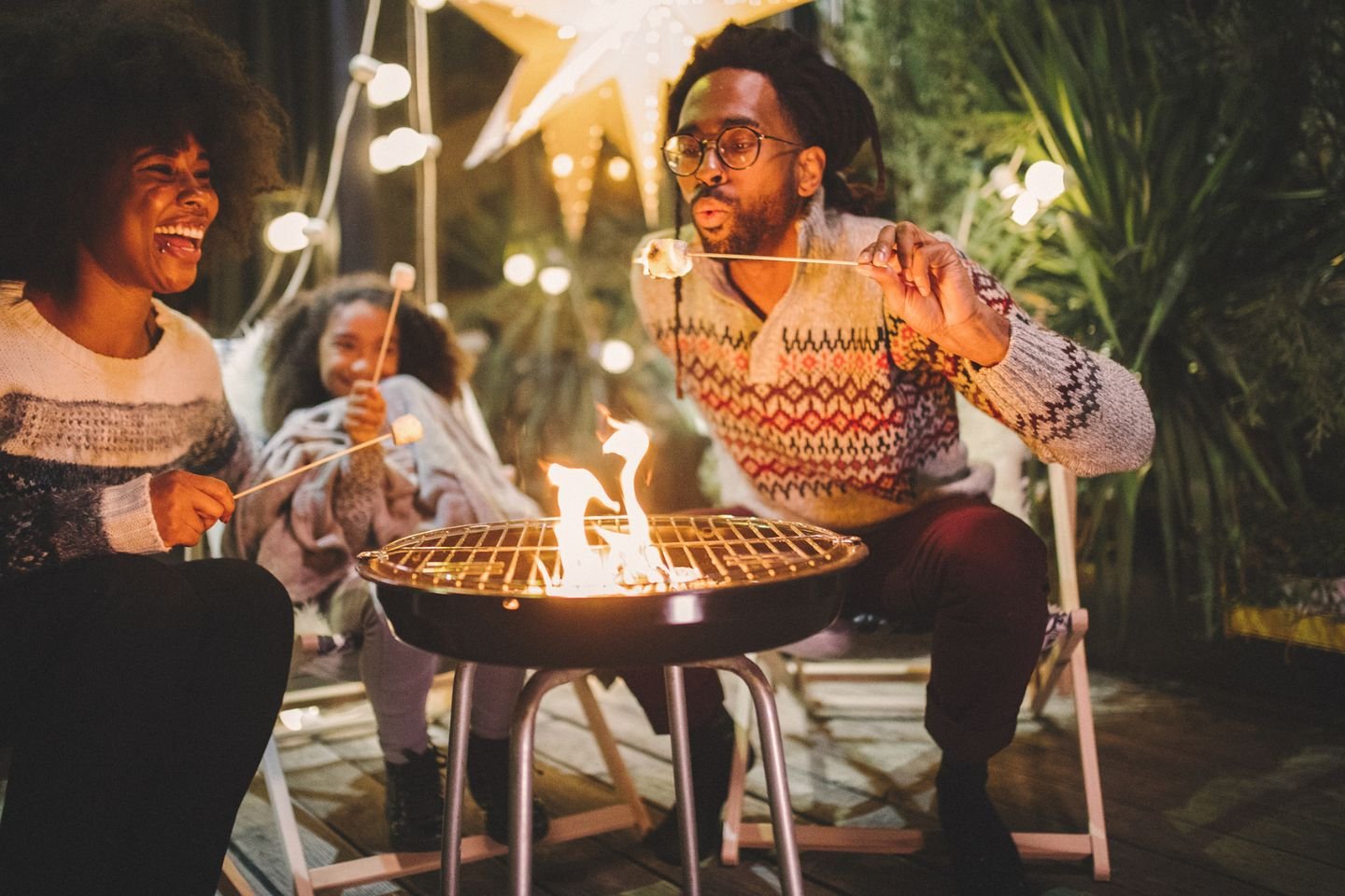 family sitting around fire