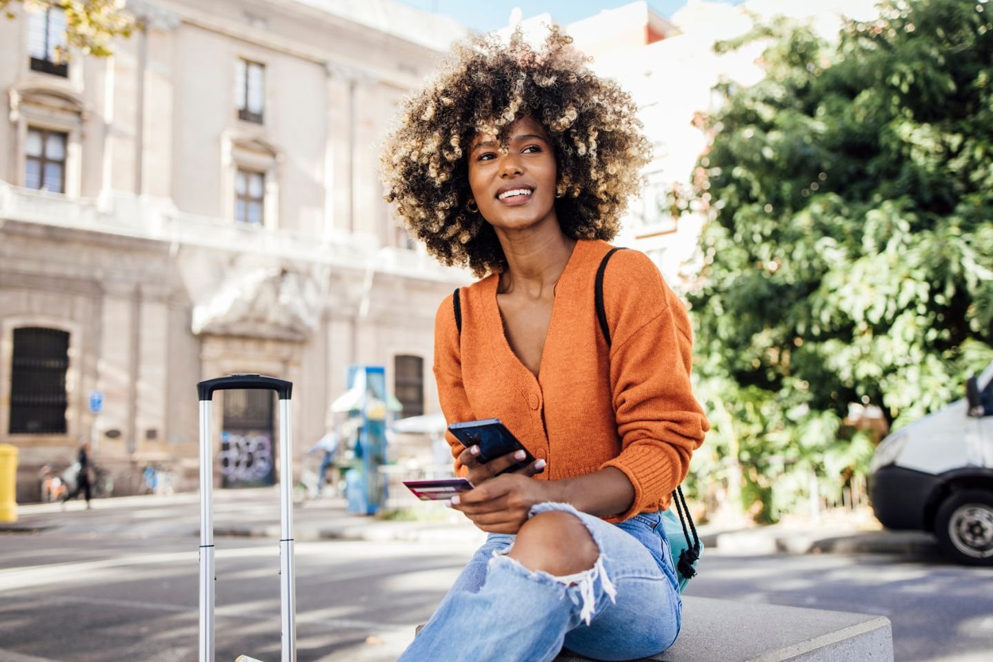 woman on phone with credit during travels