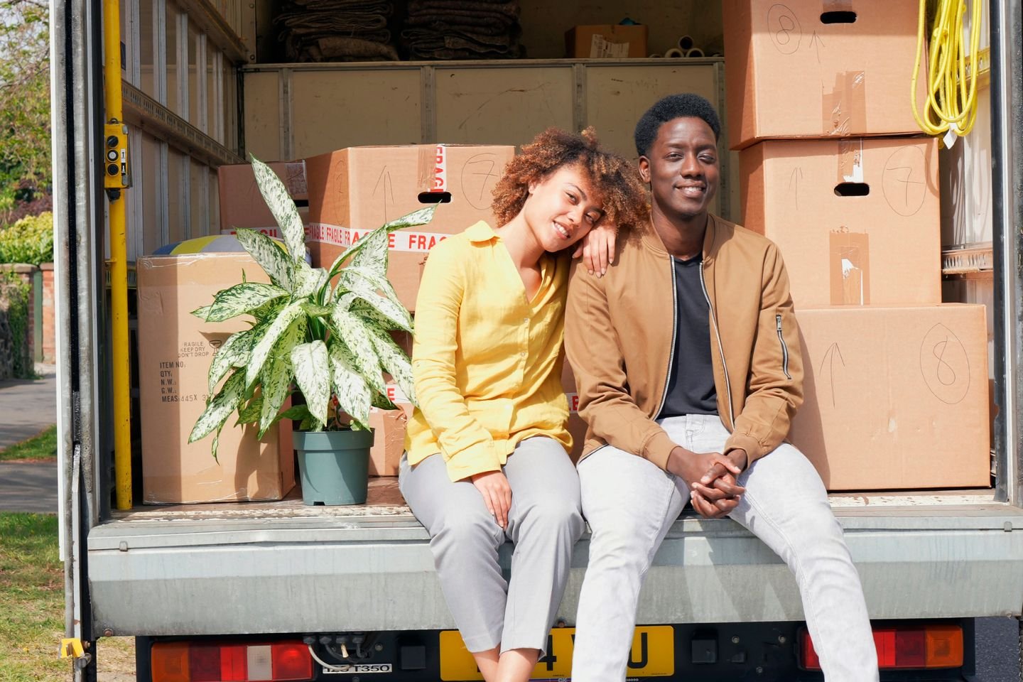 Couple Sitting on Moving Truck