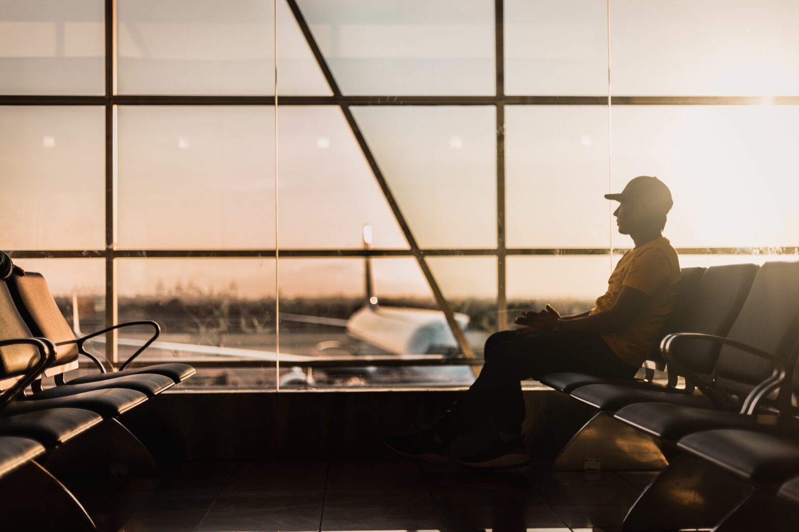 man sitting inside terminal at the airport