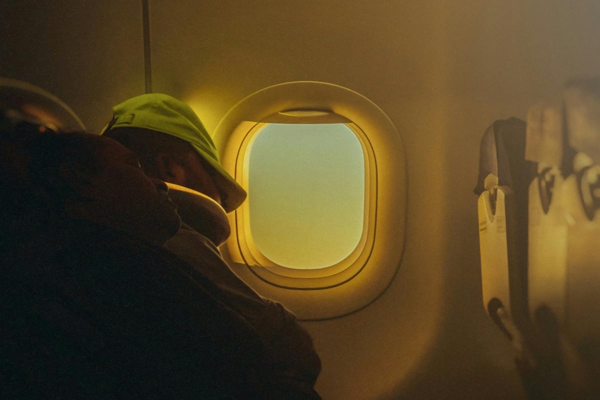 two women sleeping on a plane