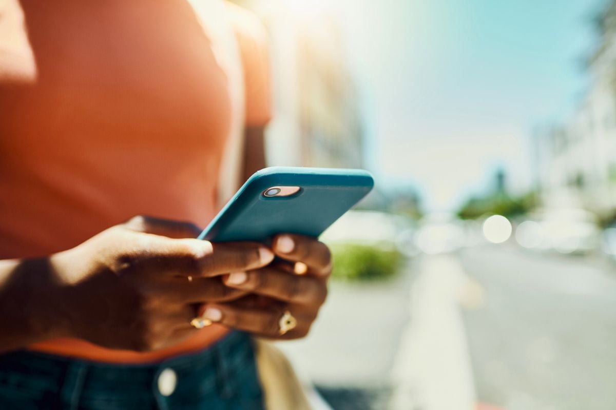 unrecognizable woman using a smartphone during a day out