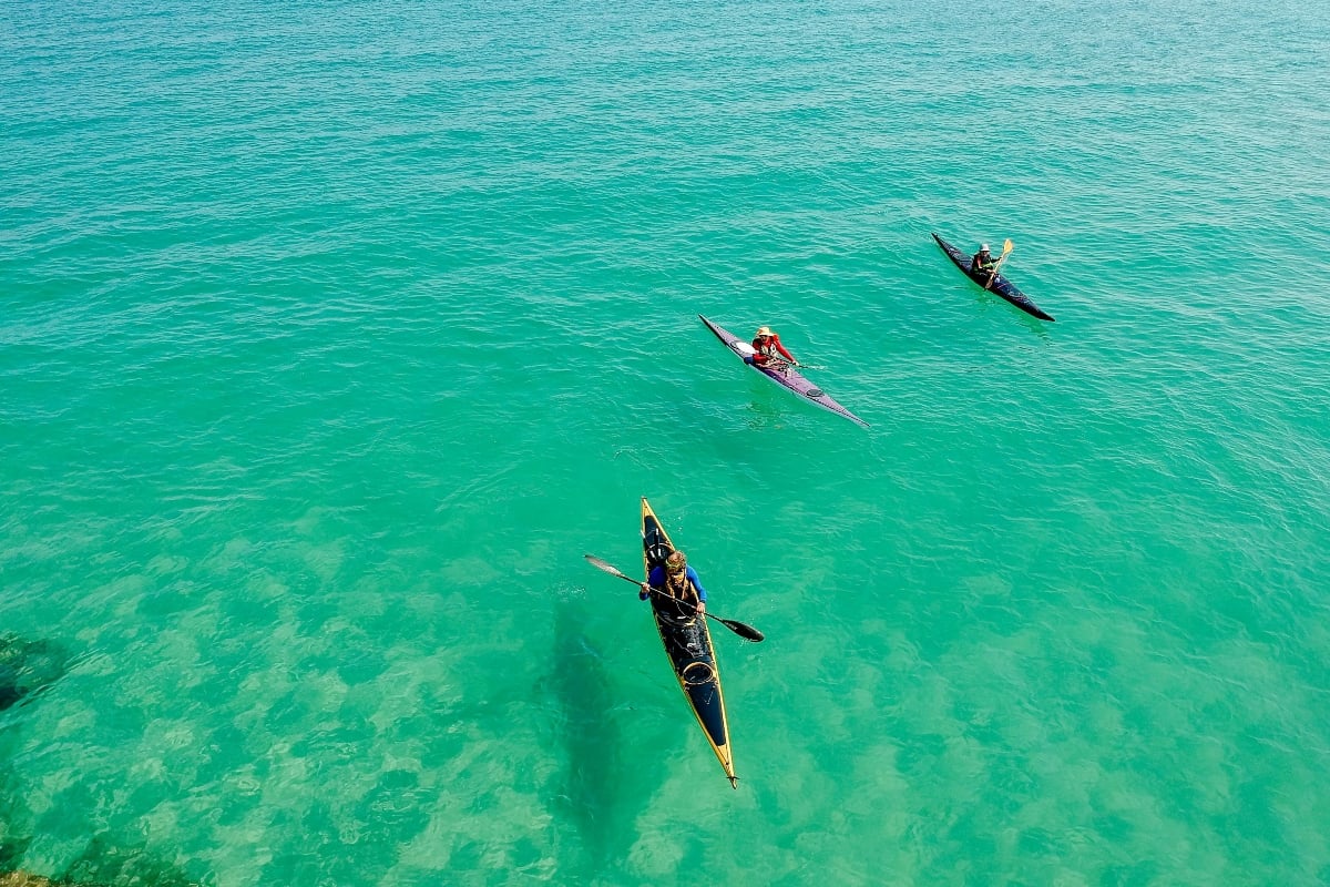 people kayaking in the ocean