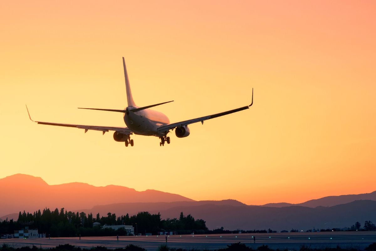 Plane landing at sunset