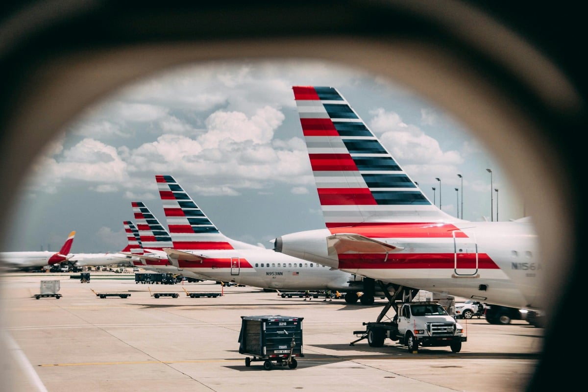 Viewing American Airlines planes, outside a plane's window, docked.