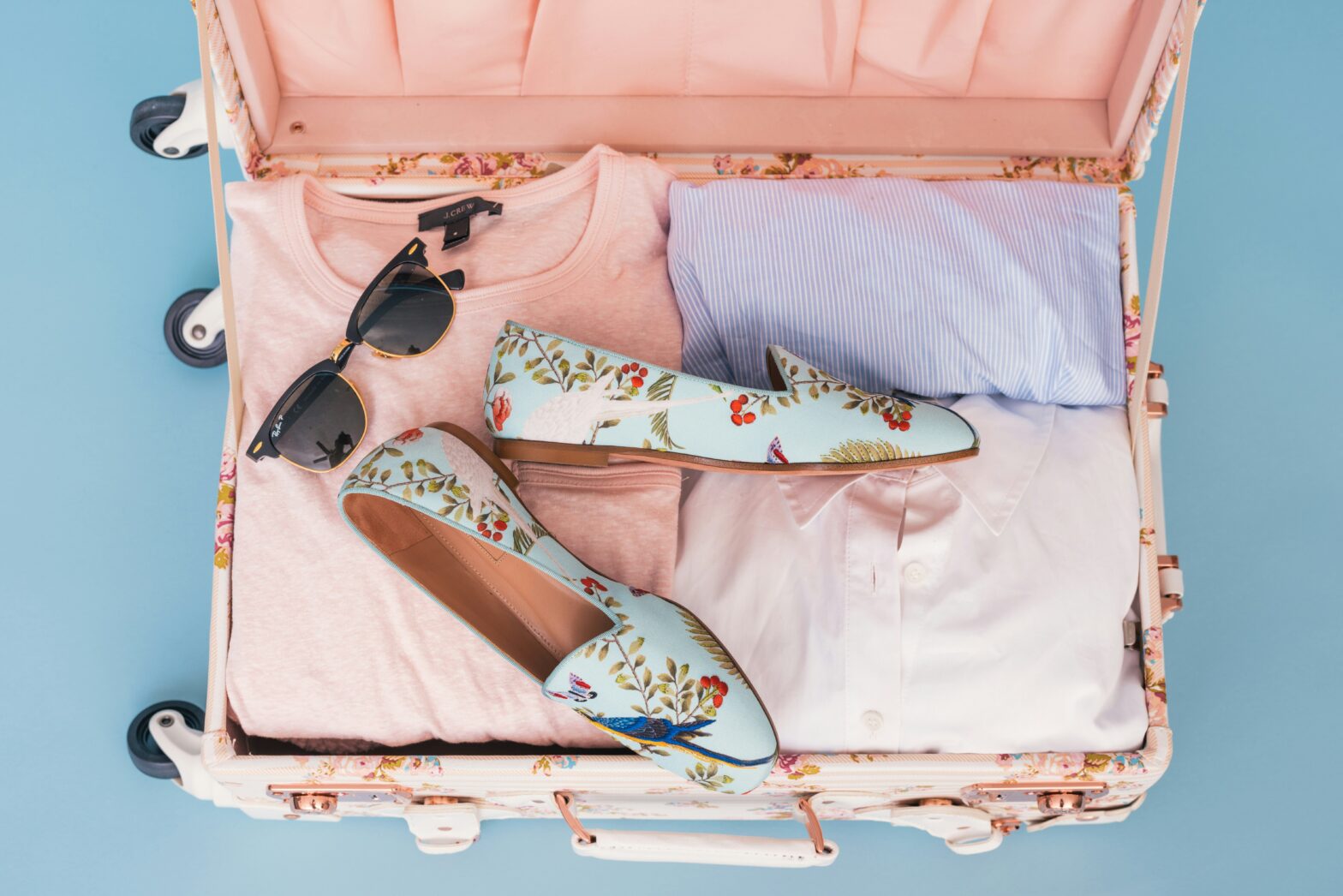 Travel items packed into a tight suitcase for a budget trip abroad.