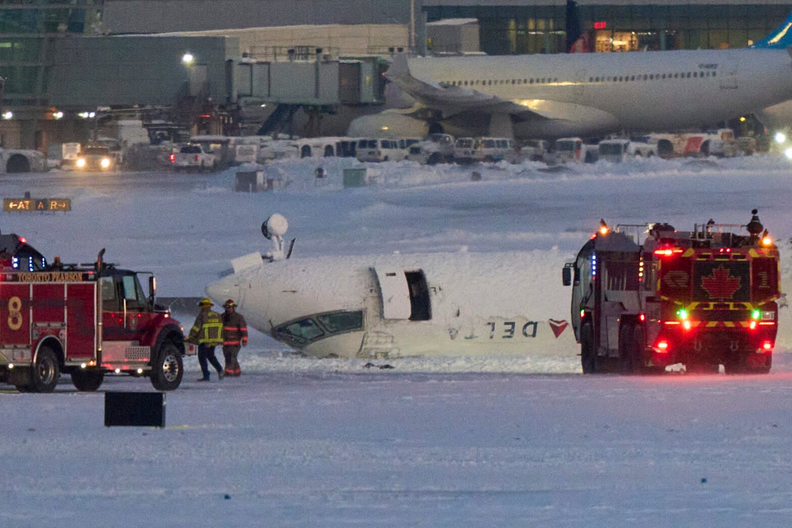 A Delta airlines plane sits on its roof after crashing upon landing at Toronto Pearson Airport in Toronto, Ontario, on February 17, 2025.