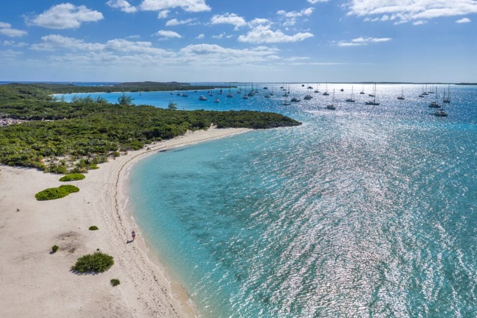 aerial view of woman walking along beach in The Exumas