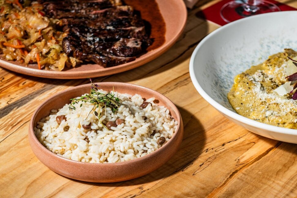 close-up of Caribbean dishes at Croix; rice and peas, steak and cabbage, and a pasta dish