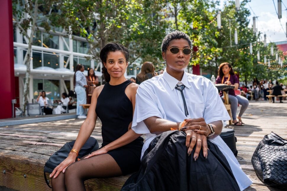 two women sitting poised outside conference