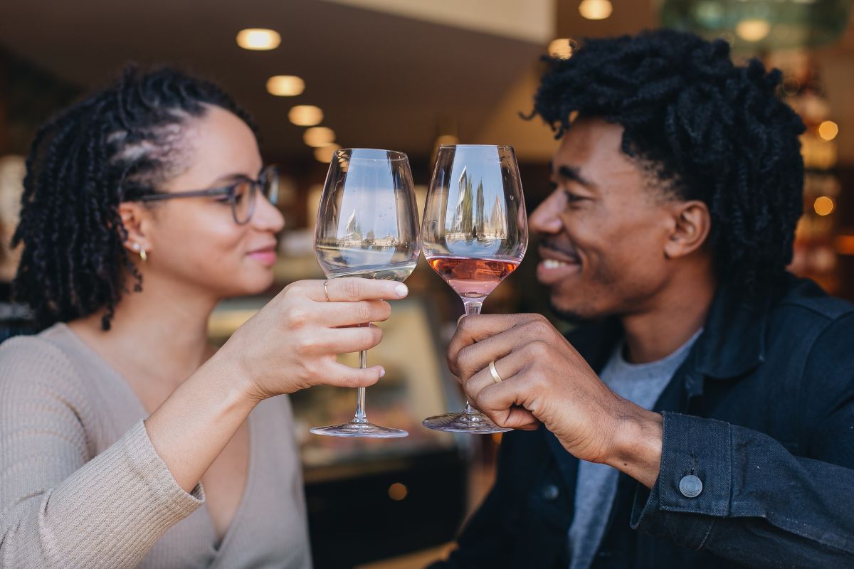 couple enjoying glass of wine together at a restaurant