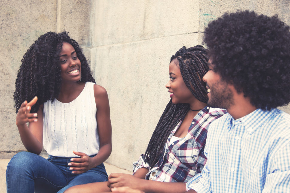 three friends sitting and talking