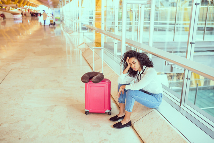 frustrated airline passenger sitting at the airport