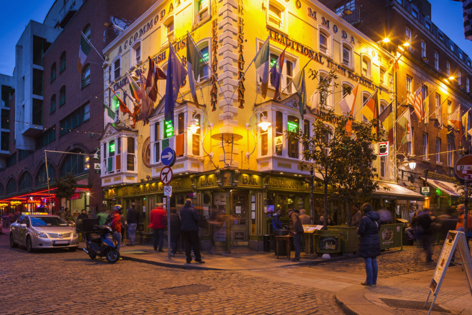 best places to visit in ireland Pictured: Ireland, Dublin, Temple Bar area, traditional pub exterior, Oliver St. John Gogarty Pub, dusk