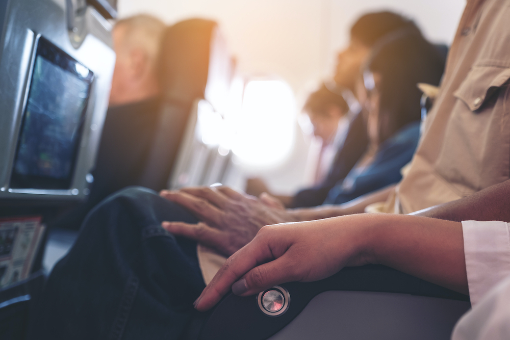 Passenger sitting on a seat row in cabin