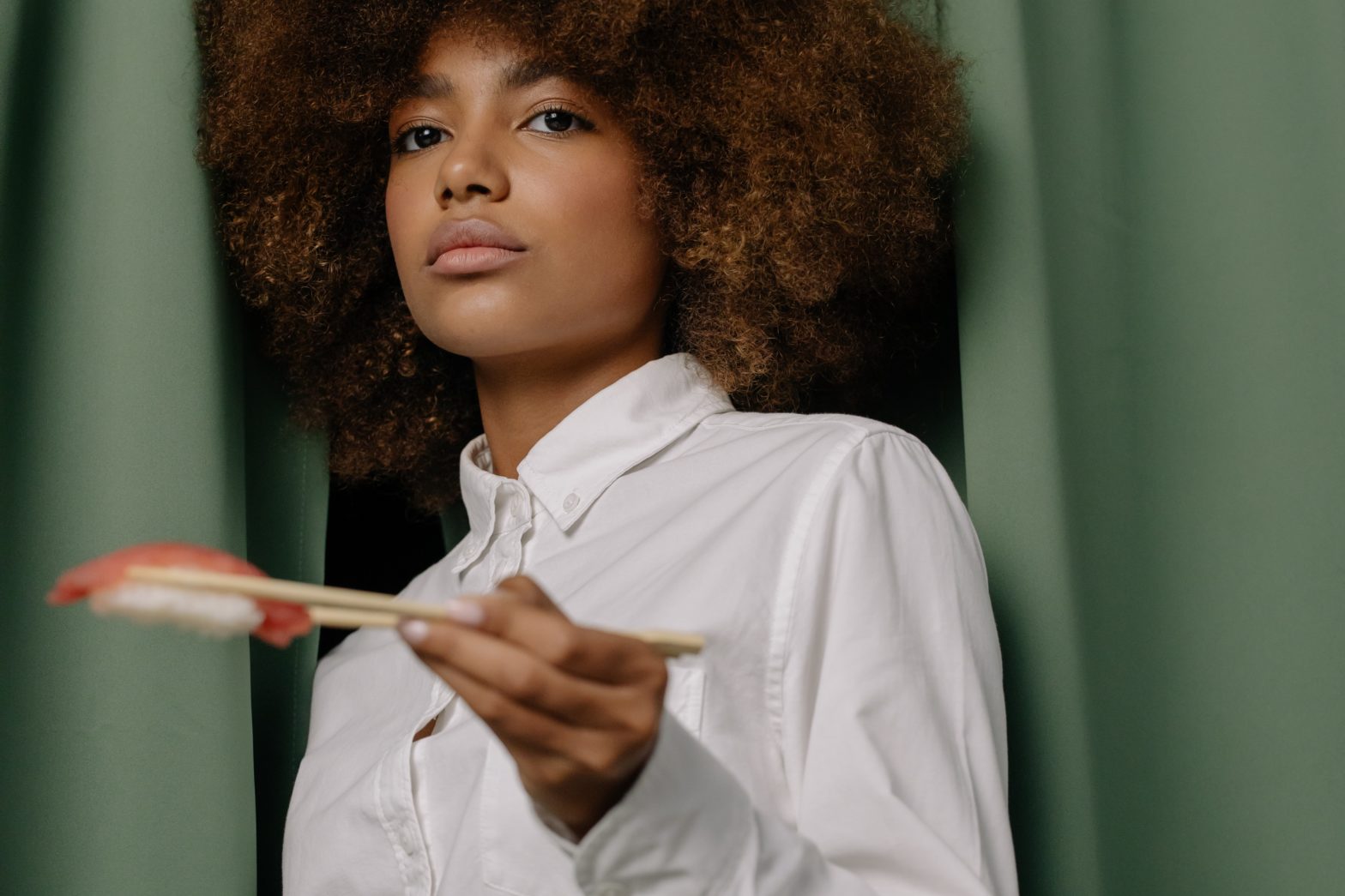 Black woman chef holding a spoon