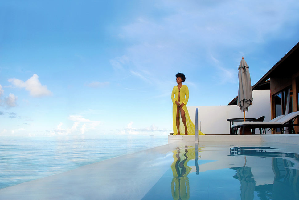 Woman standing at the edge of a pool.