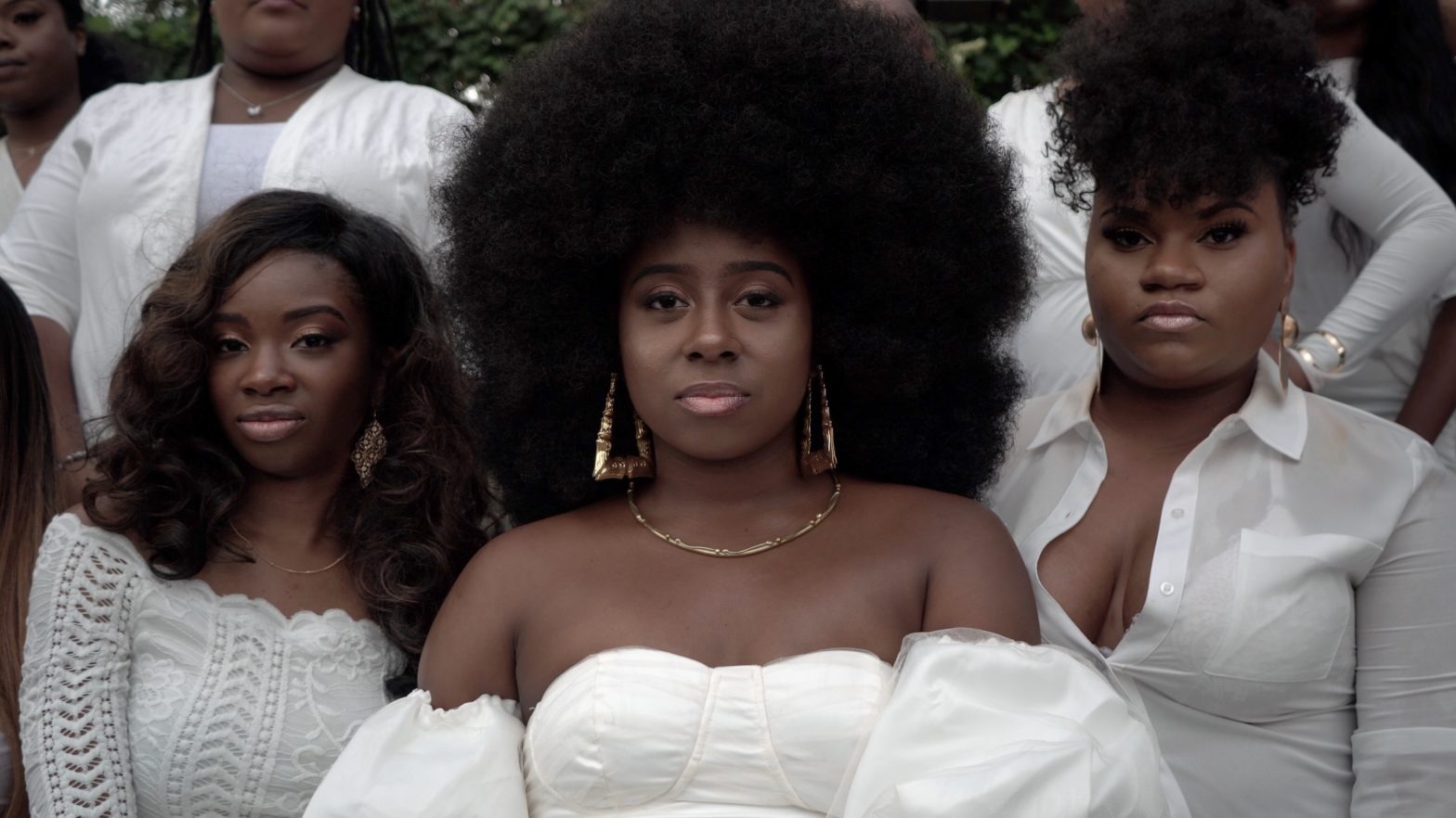 Black women with natural hair wearing white