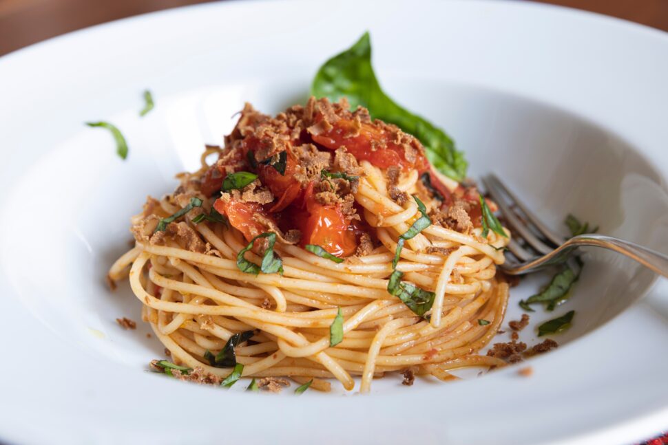 close up shot of pasta dish with tomatoes representing the cuisine of Catania, Sicily