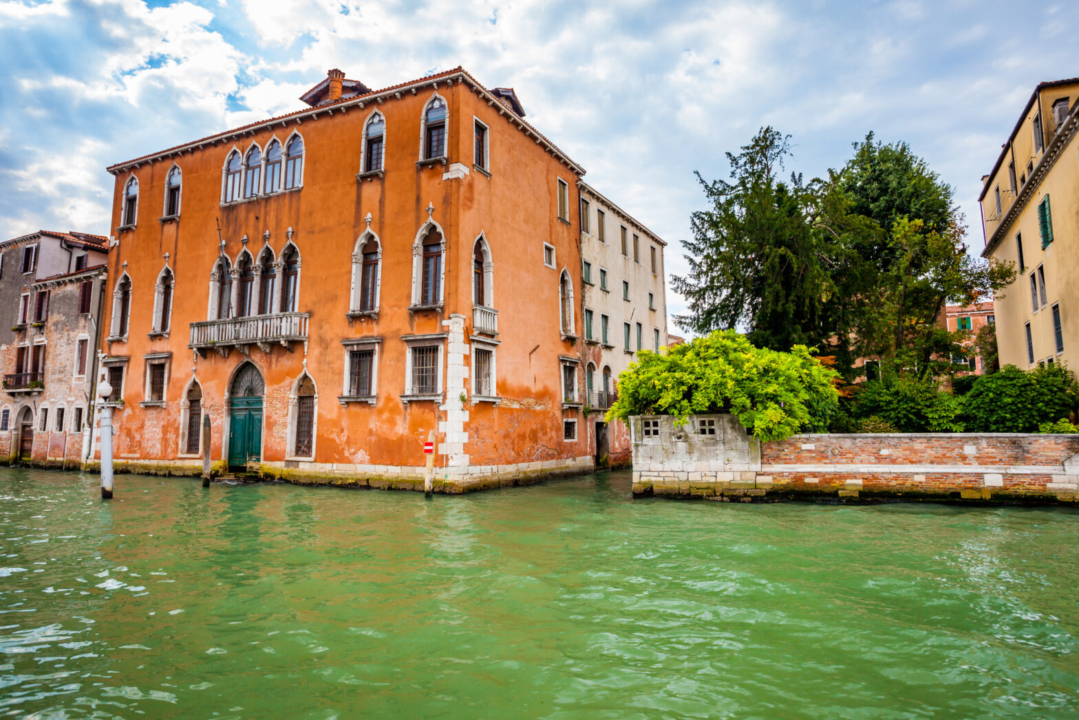 Colourful exteriors of villas and palazzo with the tranquil waters of the Grand Canal in the Venice Lagoon area.