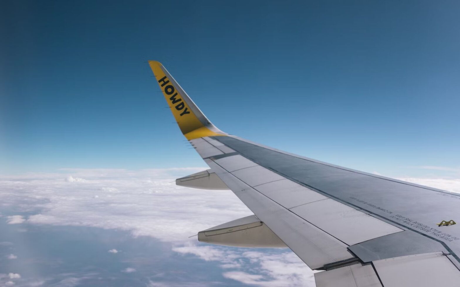 wing of a Spirit airlines plane in the air - Spirit employee tapes wing of plane