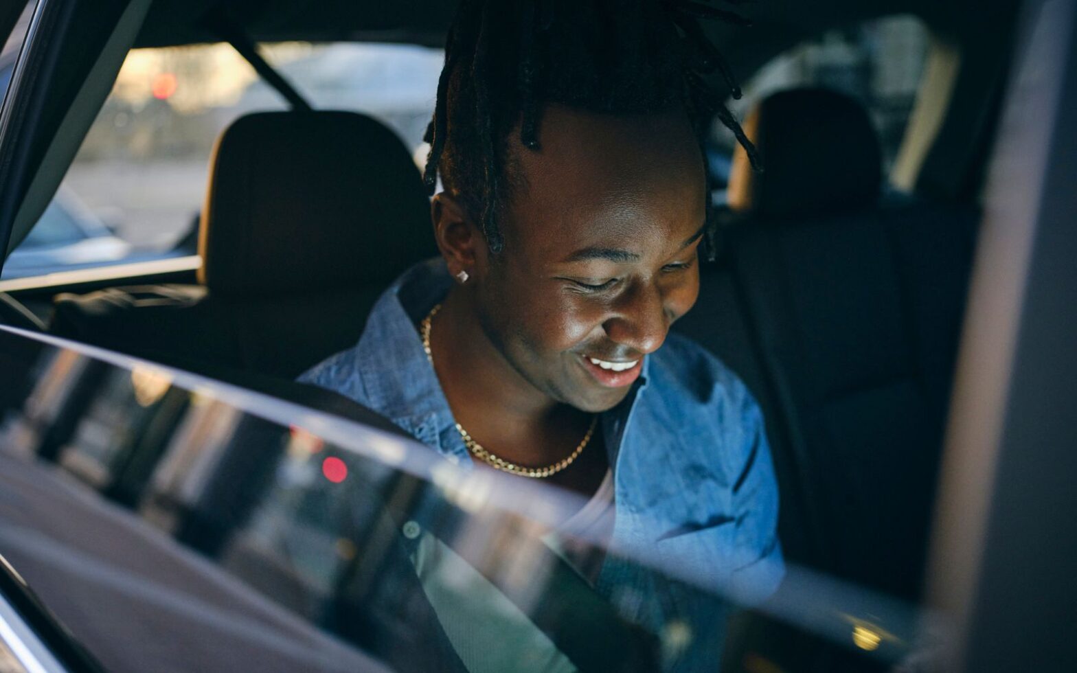 man sitting in back of Uber rideshare