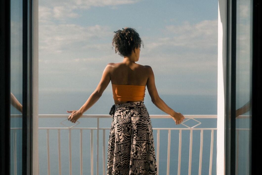 black woman standing on balcony