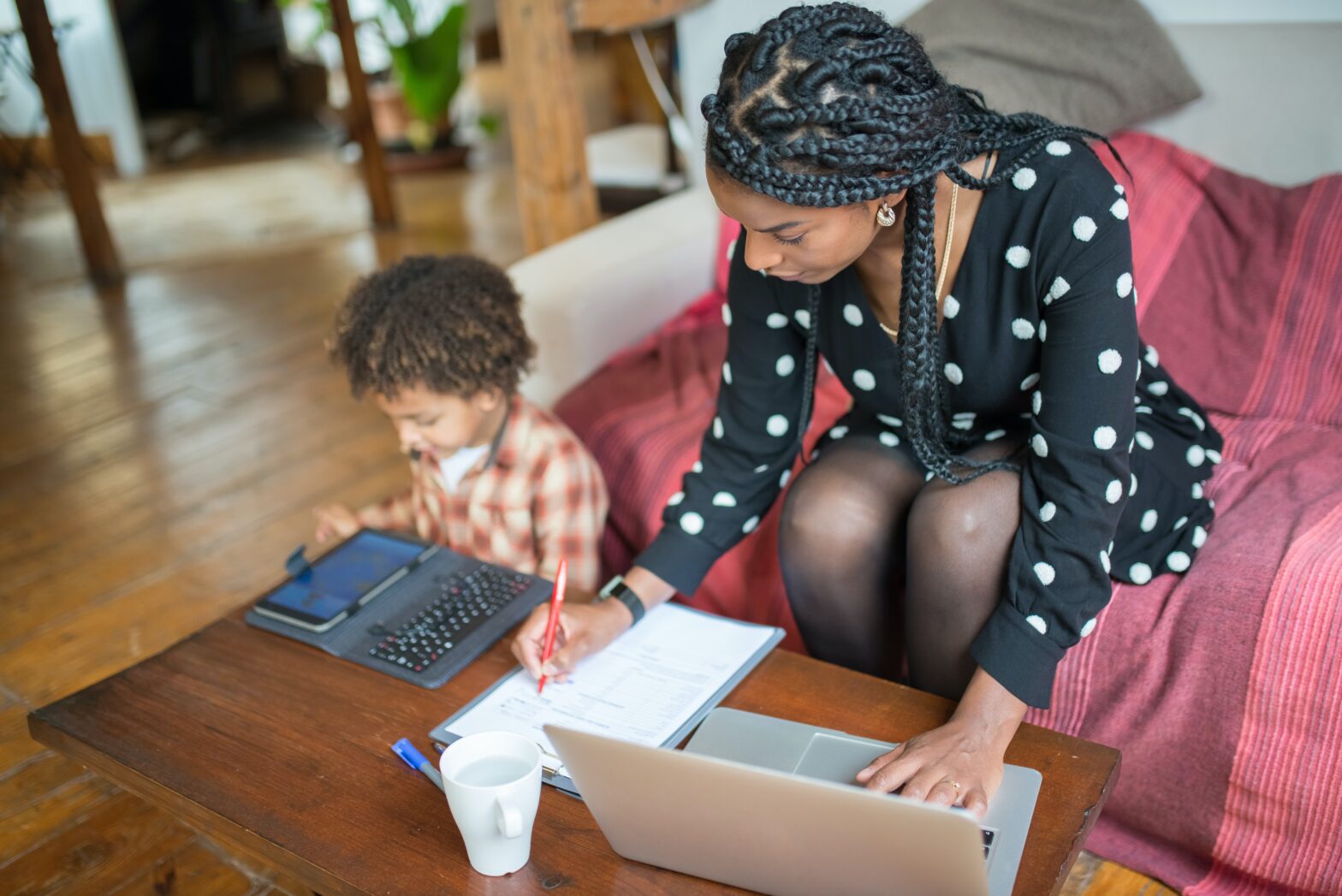 mother with child on laptop while working remotely