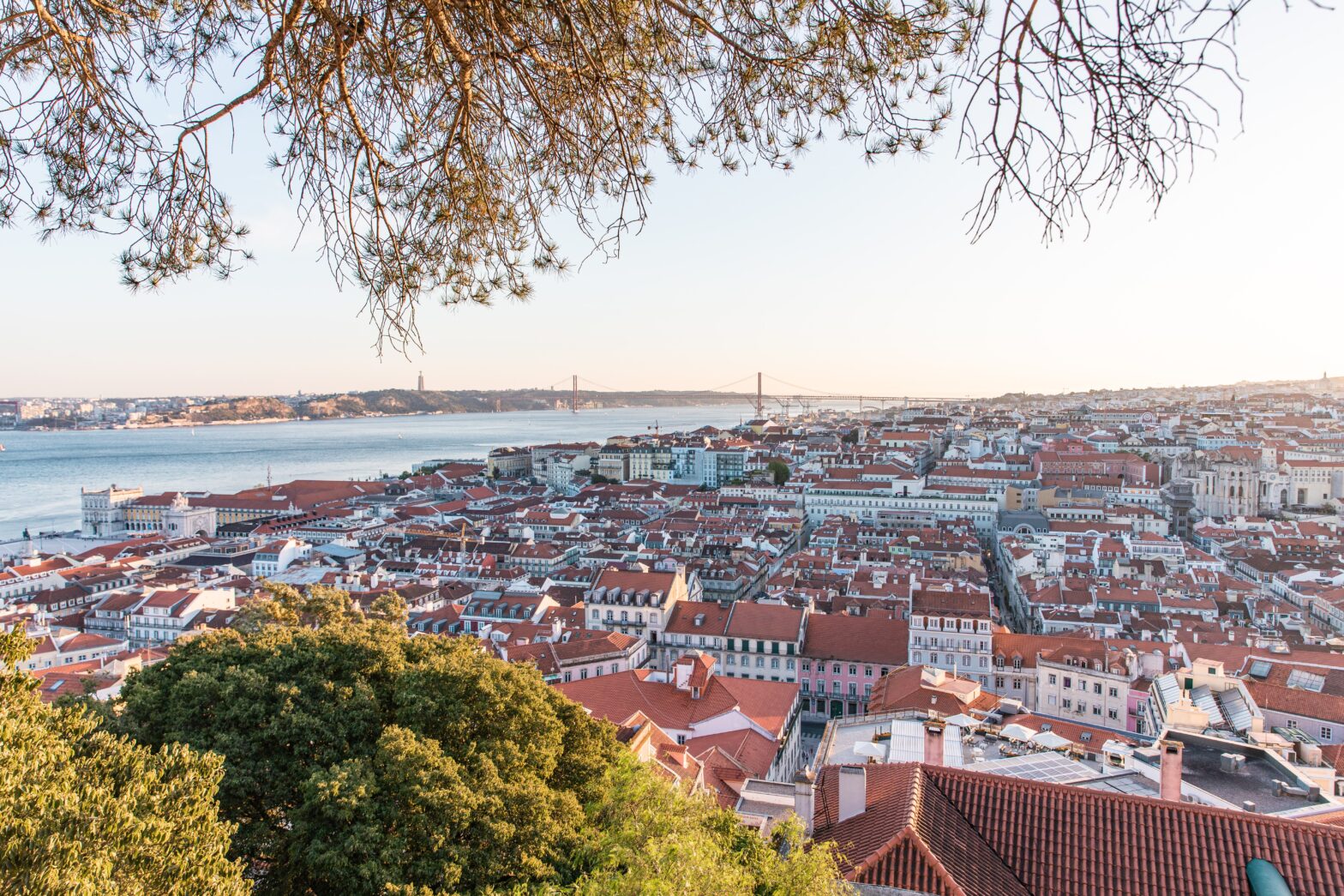 hillside overview of Lisbon Portugal terracotta roof homes and the sea