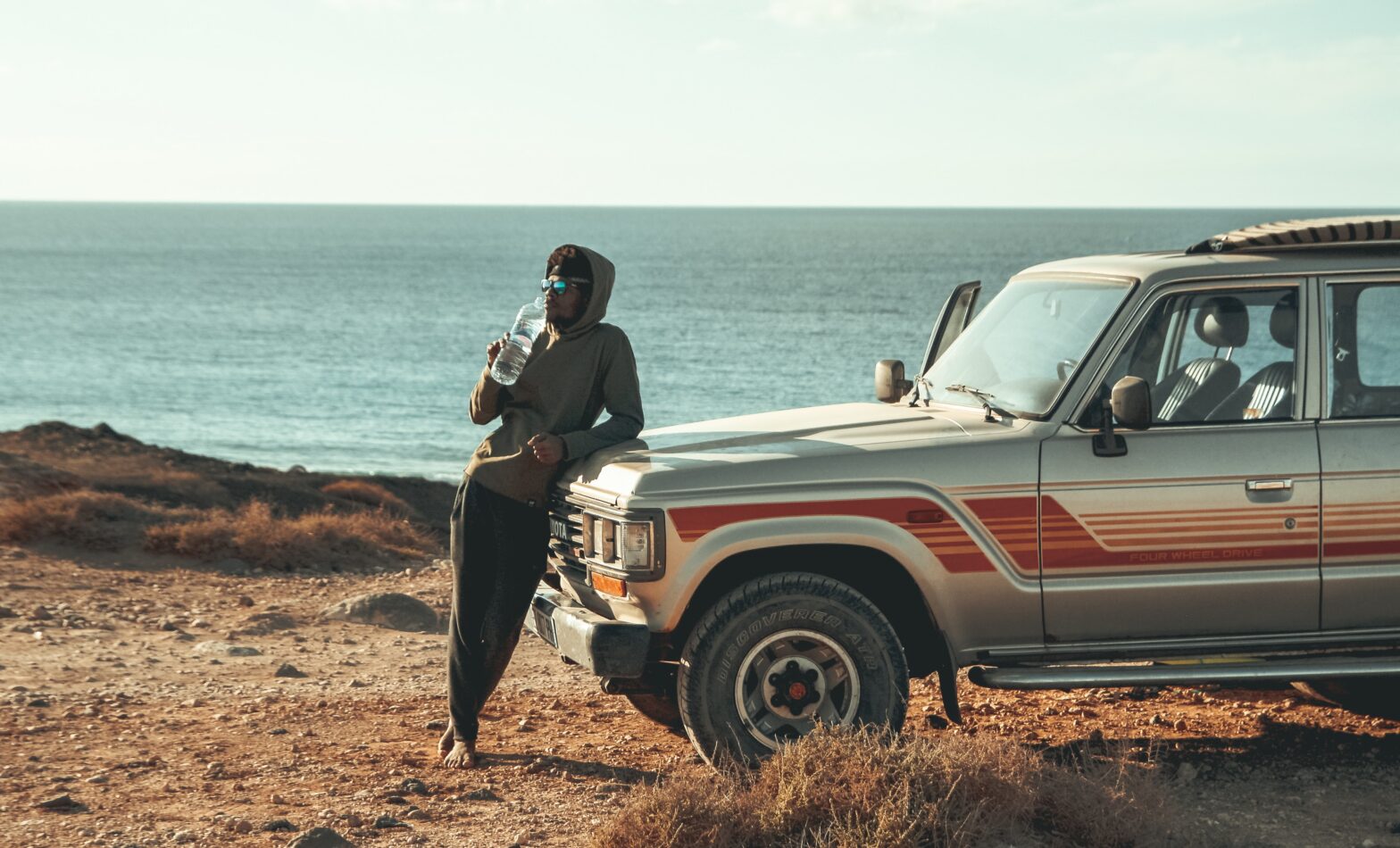 Man Posing On Hood of Car