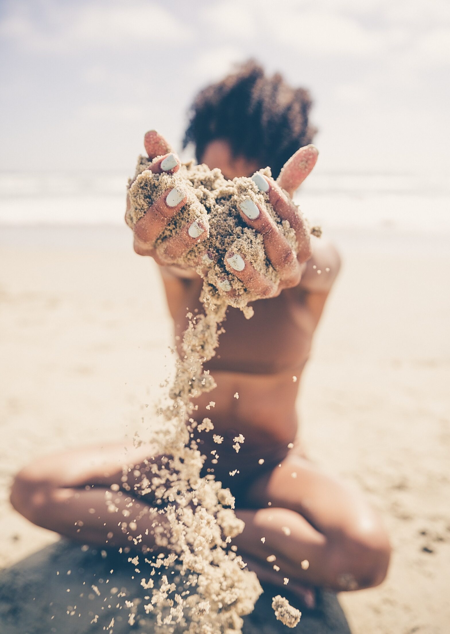 woman on the beach playing in sand