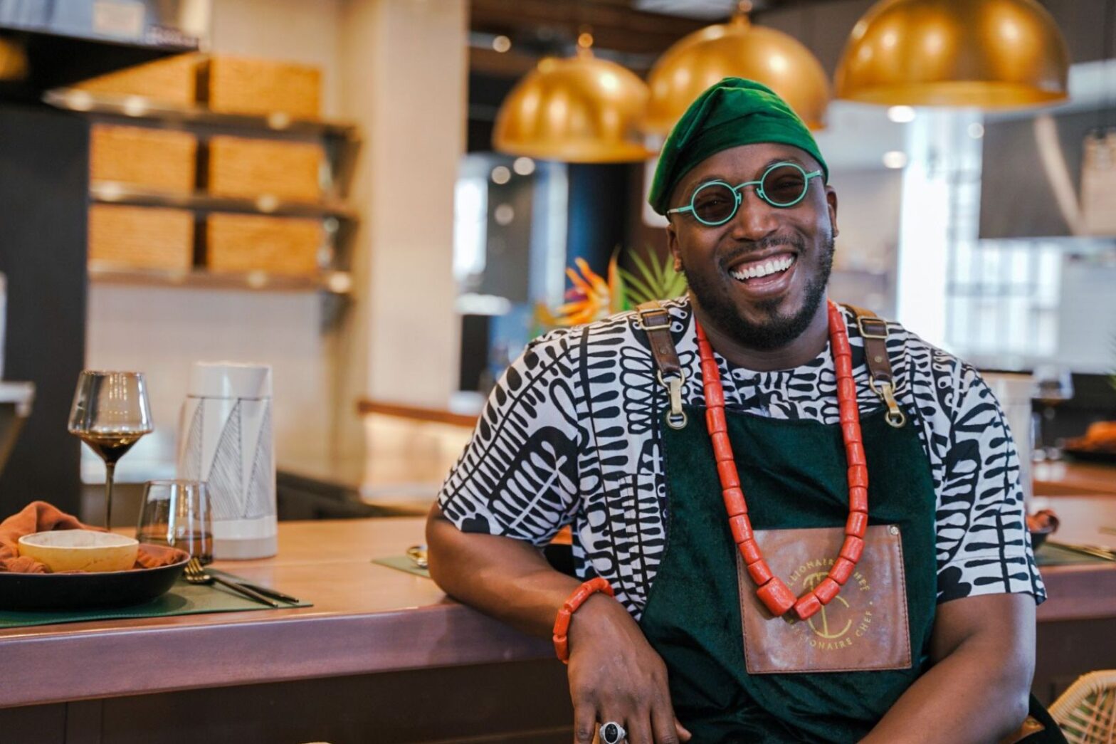 Chef Tolu Eros smiling in restaurant