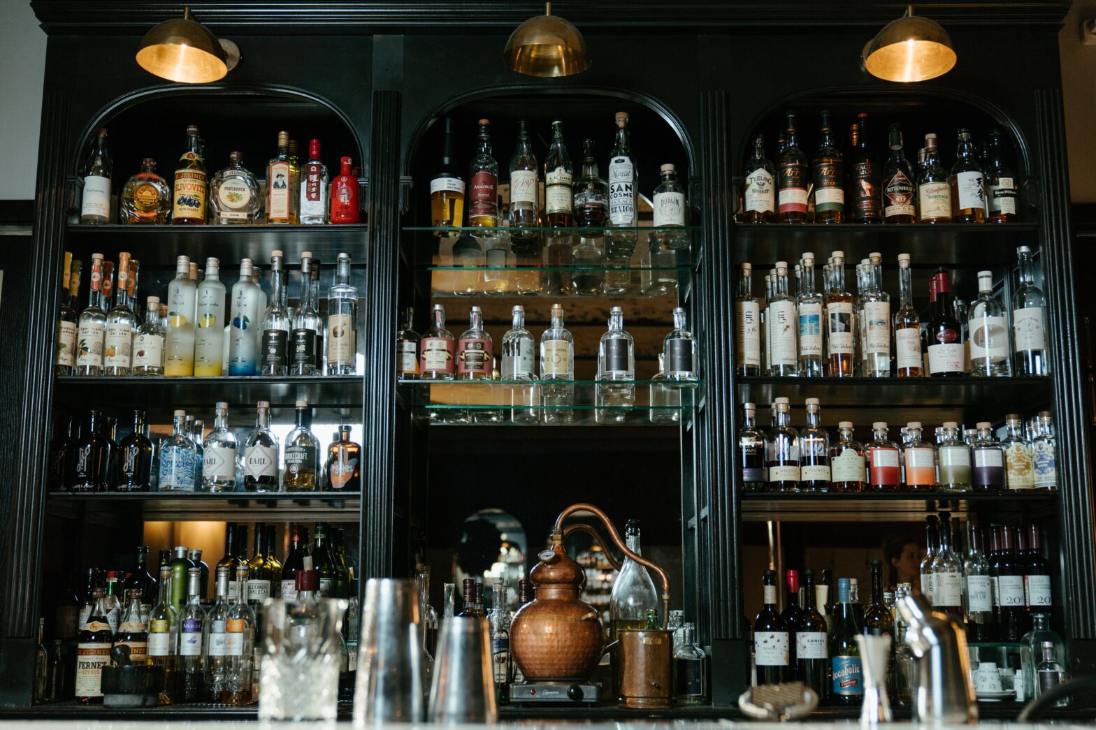 Bottles on shelf at a bar