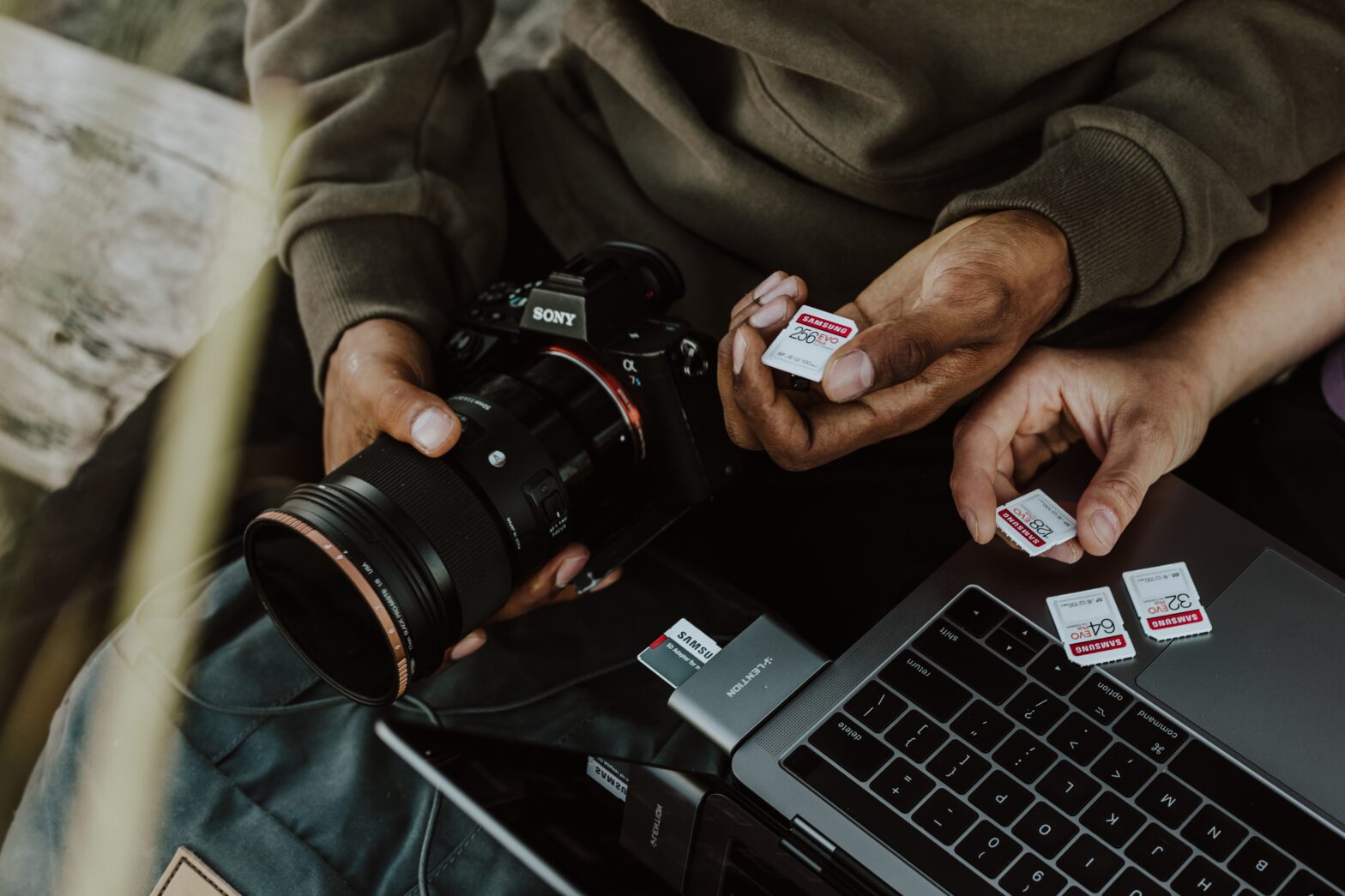 person holding camera and memory cards