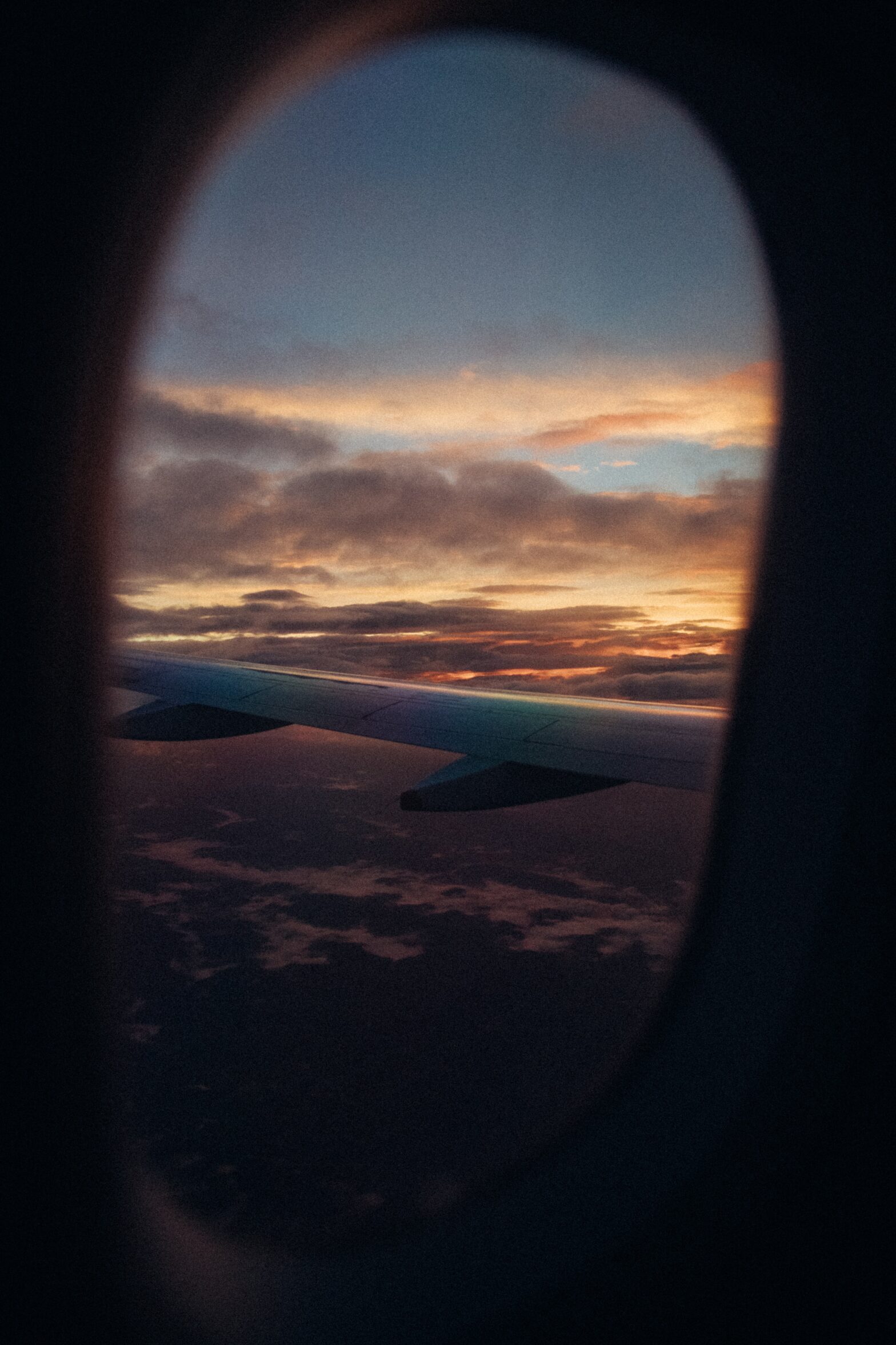 The view from an airplane window as someone travels during shoulder season.