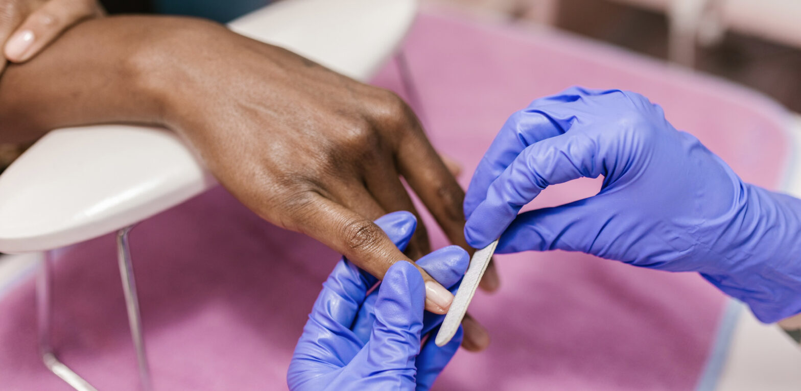 Pictured: a woman getting her nails done and ready to go on vacation.