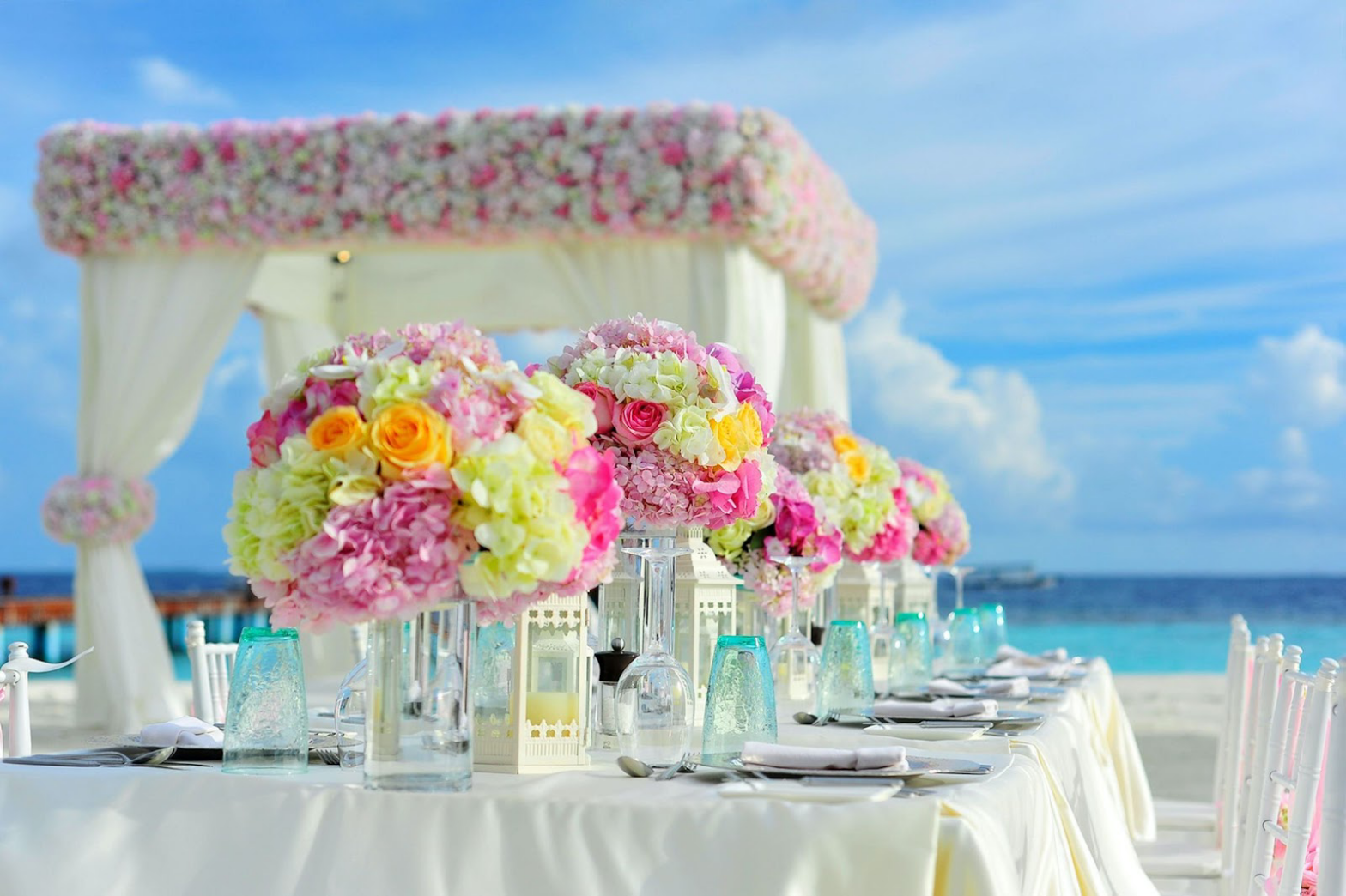 It's not easy planning a destination wedding for under $5000; but it's not impossible. Take a look at these all-inclusive wedding packages under $5000. Pictured: an outdoor beach front wedding venue.