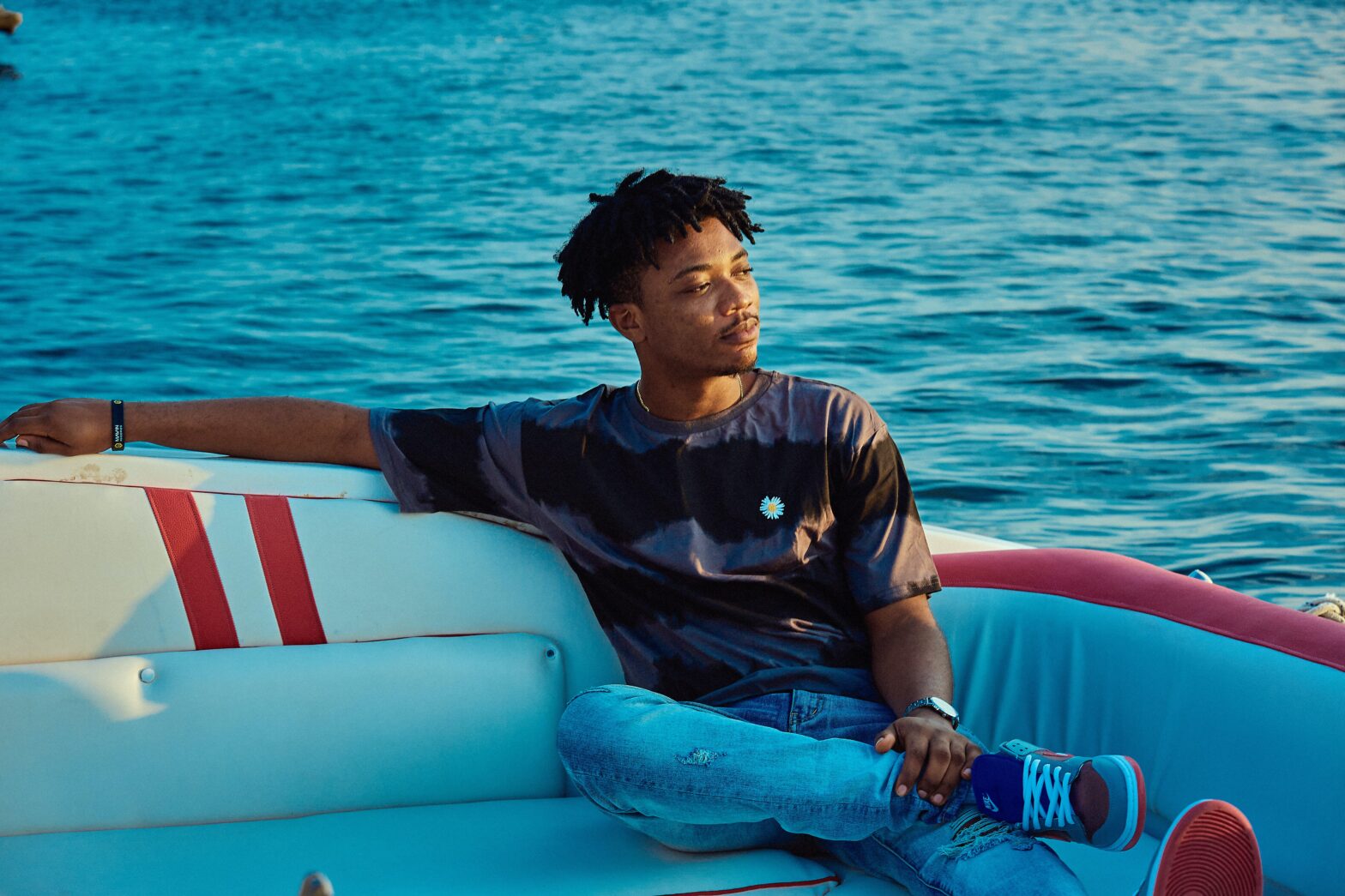 man sitting on a boat on the water