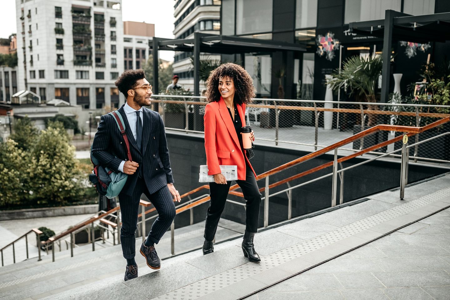 two Black professionals walking in a city