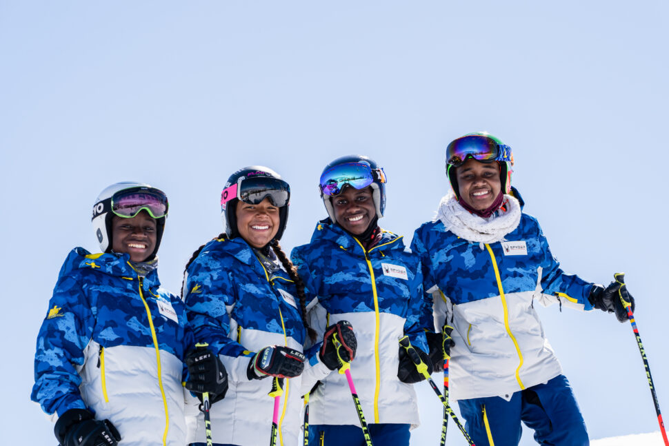 Four members from the National Brotherhood of Snowsports stop for a group picture.