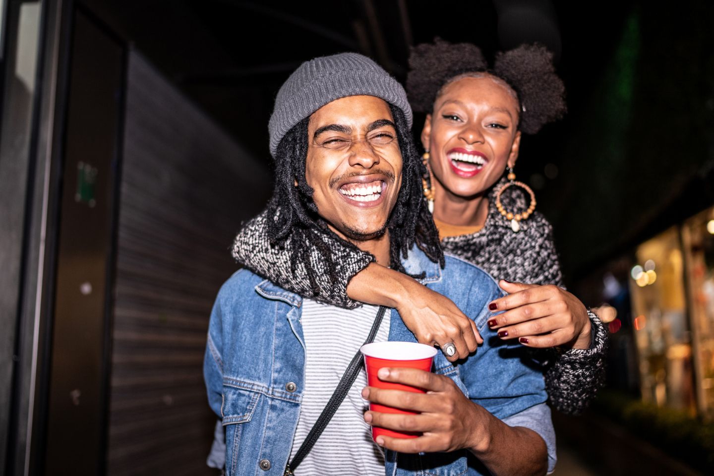 two people laughing at a party