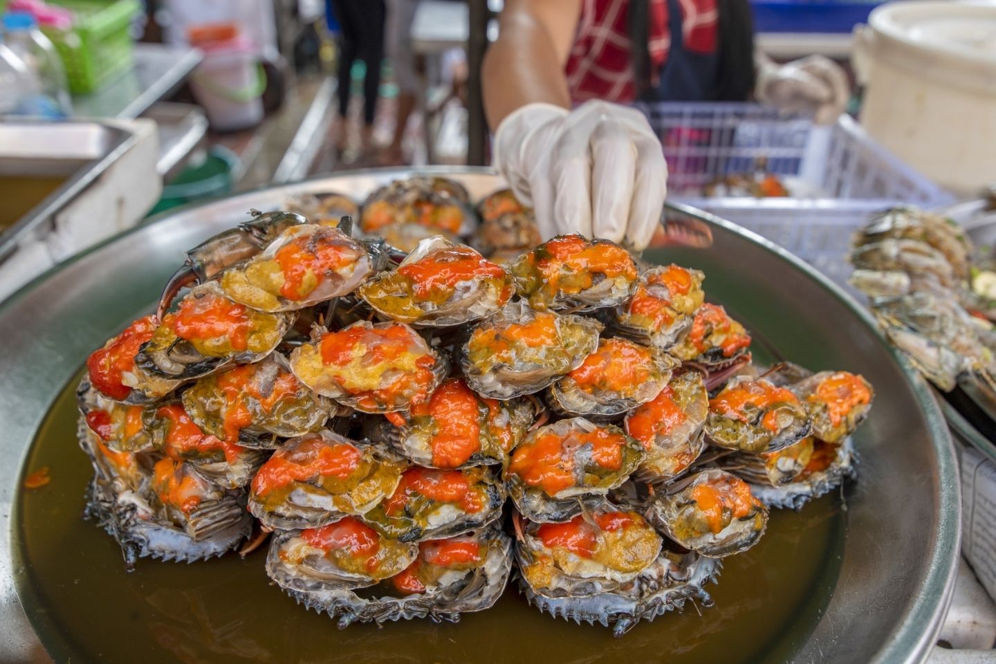 person serving seafood at a festival