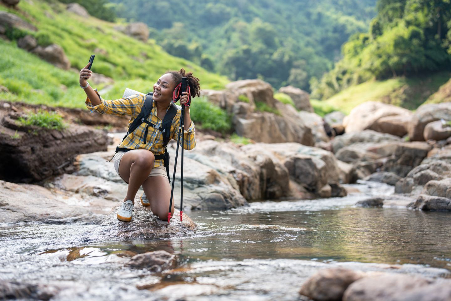 woman taking a selfie while hiking in nature