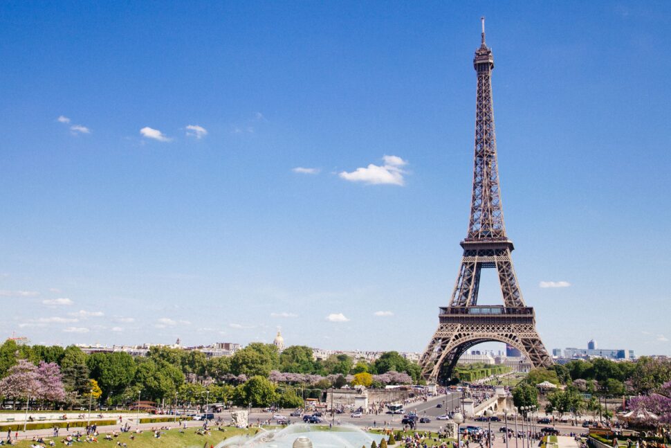 The Eiffel Tower is an iconic structure that is located in the seventh district. Learn about what else it offers to travelers. pictured: sculpture gazing at the Parisian tower