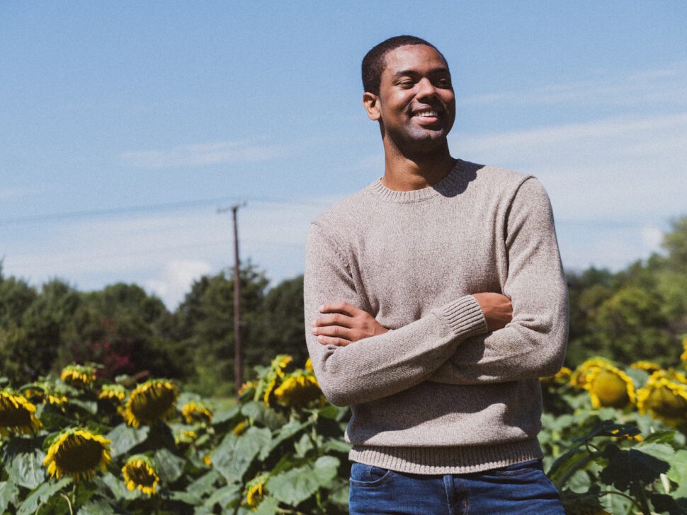 man standing in sunflower field