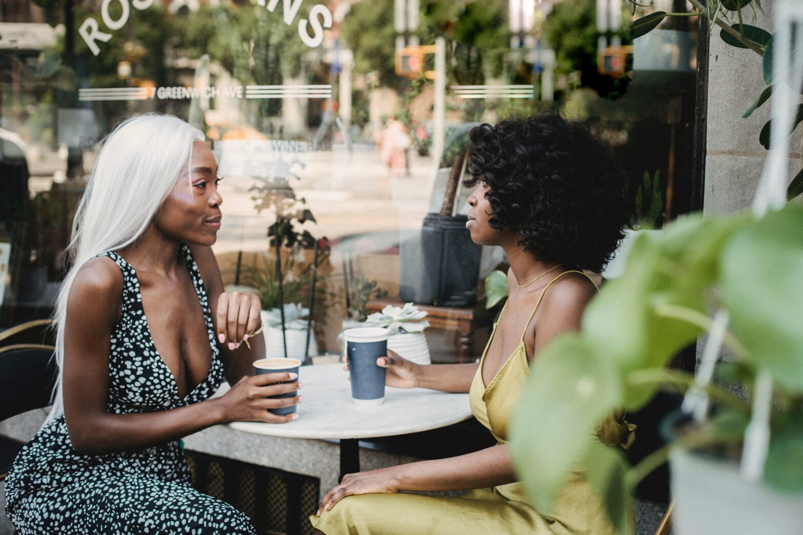 two women sitting at a coffee shop